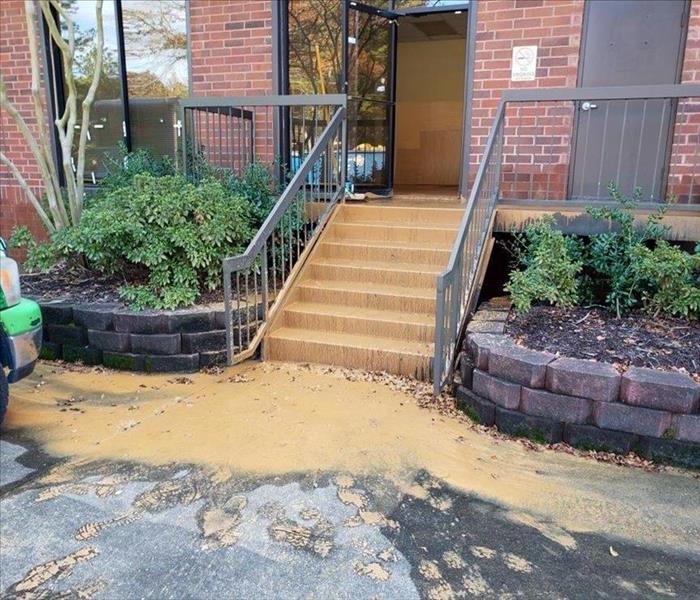 Leftover mud going down the stairs of a Nashville office after a flood
